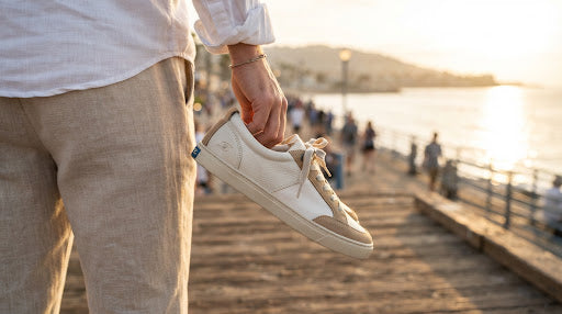 Hand holding a Shoreline sneaker